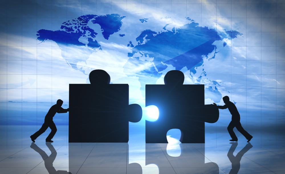 two men push 2 large puzzle pieces together