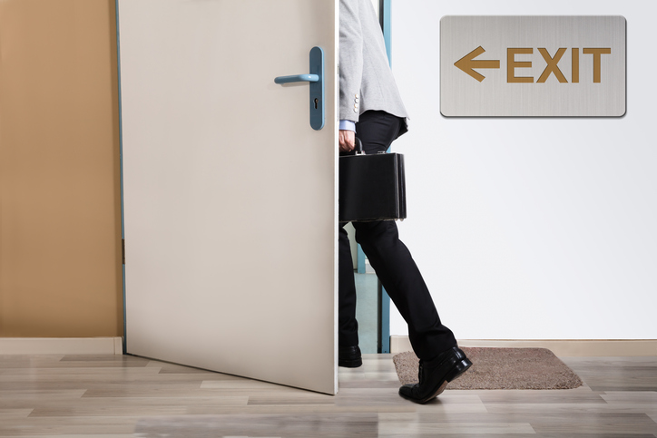 businessman leaving through door