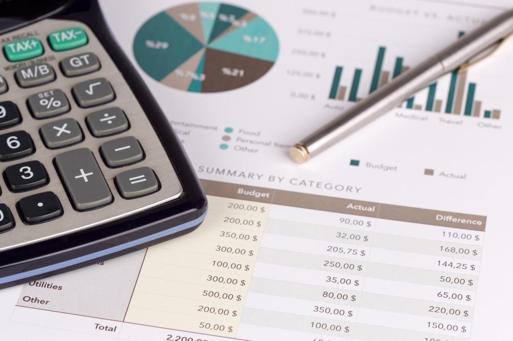 budget details with a calculator and pen