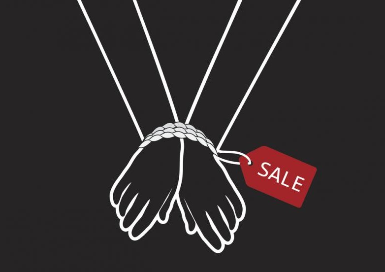 human trafficking concept: hands bound by rope with a sale tag attached