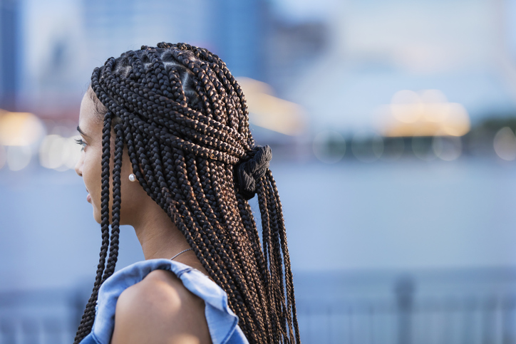 Young mixed race woman with cornrow braids