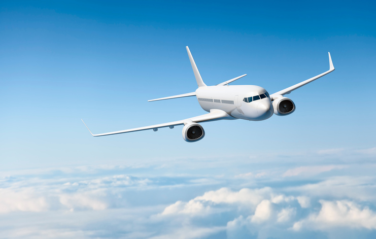 airplane flying through sky over clouds