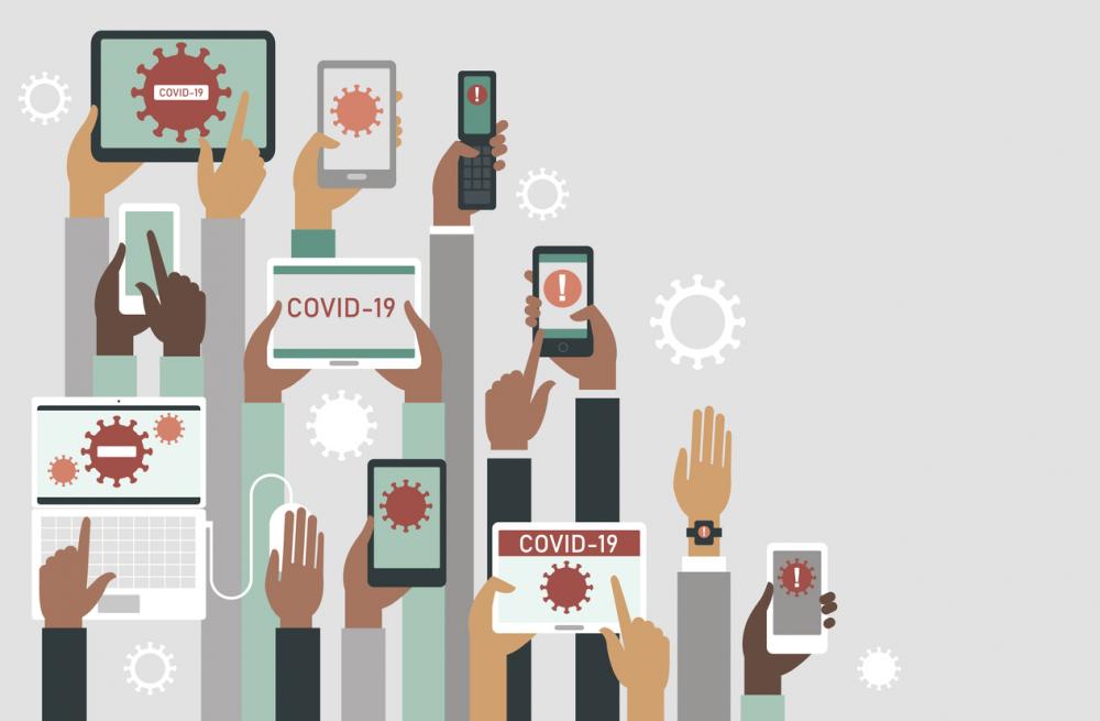 Human hands holding various smart devices with coronavirus alerts on their screens
