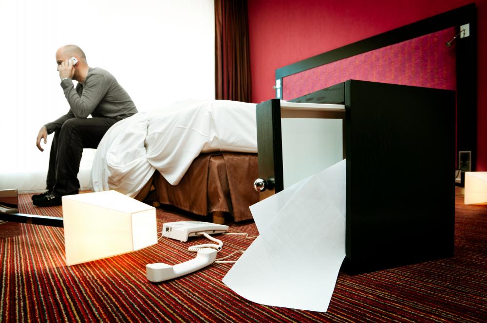 man on phone call after finding his hotel room broken into