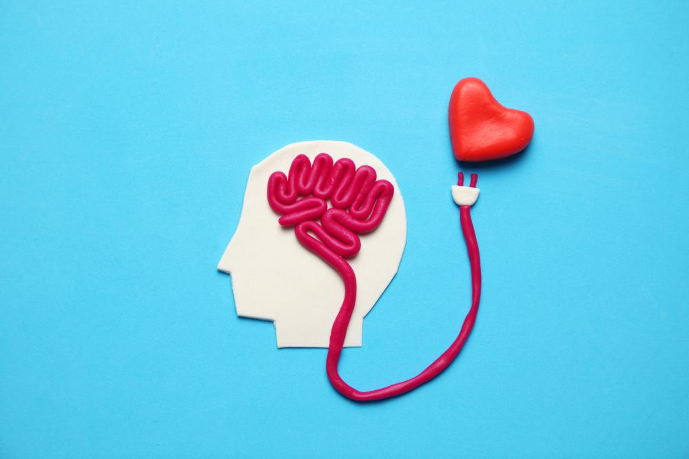 Figure of man with brain stemcord reaching toward red heart
