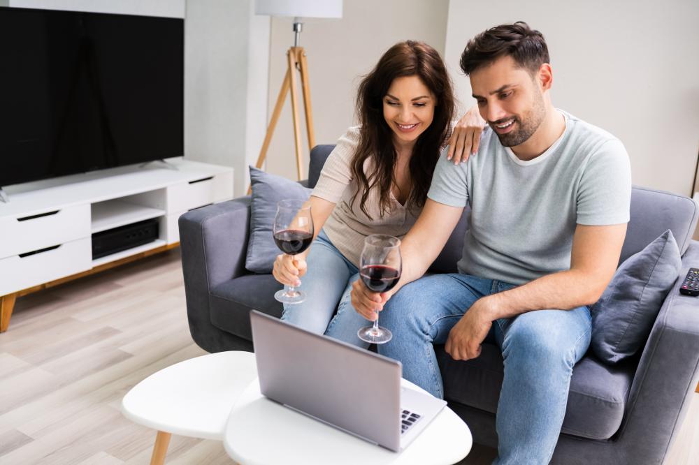 man and woman taking part in virtual wine tasting