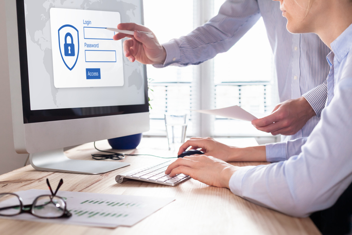 two employees log onto company computer