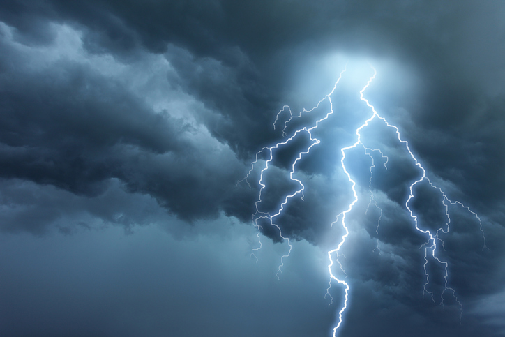 thunderstorm lightning against dark storm clouds