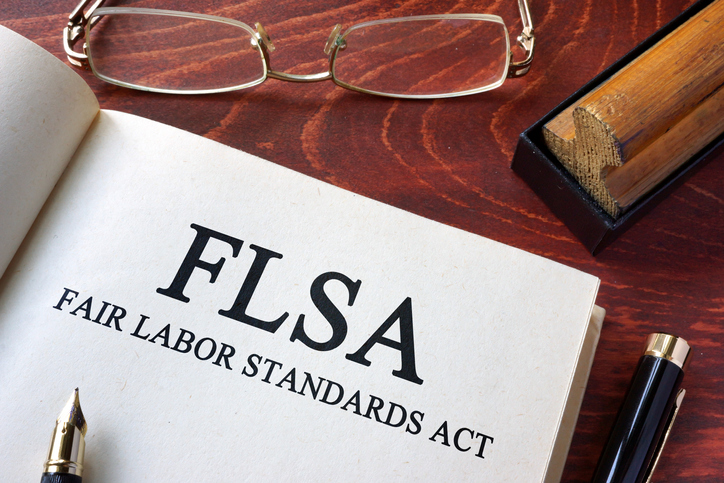 Page with FLSA fair labor standards act on a table.