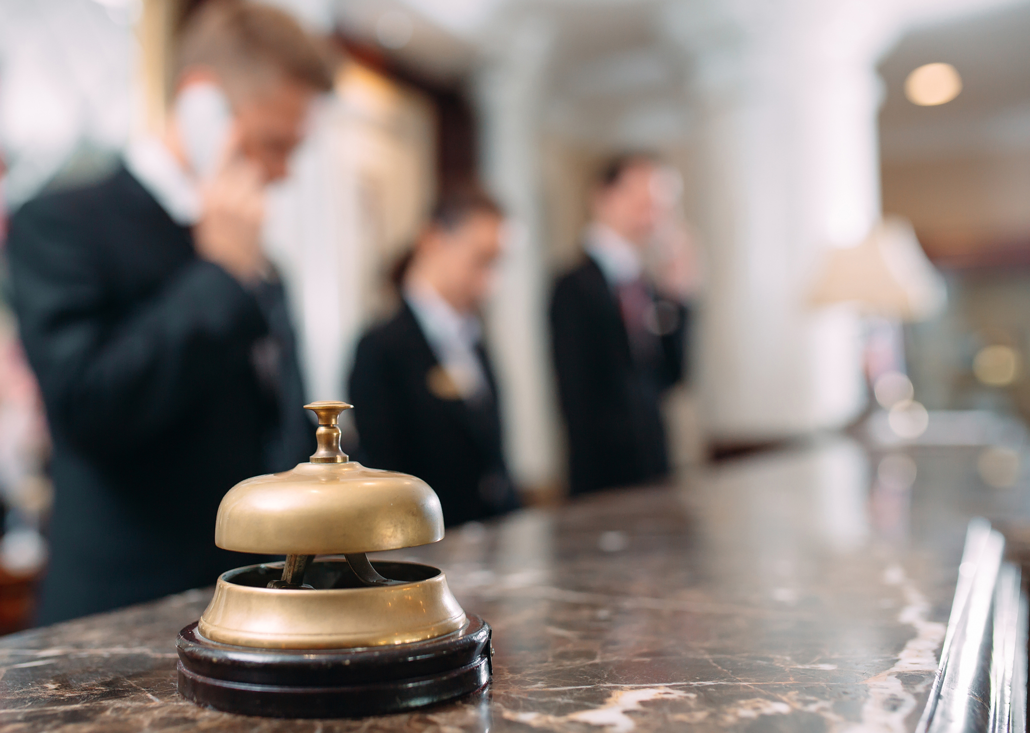 closeup of service bell with staff in the background
