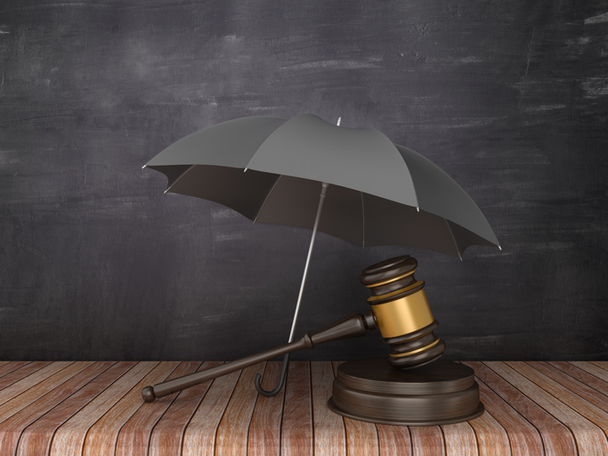 Umbrella with gavel on wood floor