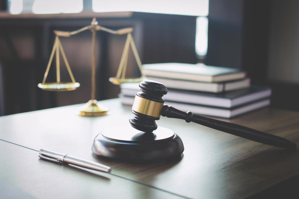 gavel and scales on wooden desk